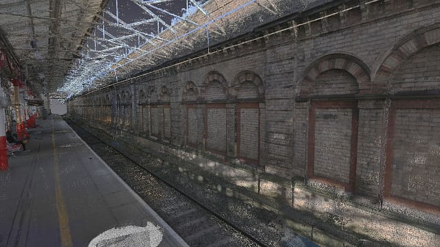 Coloured point cloud of a station platform, railway and adjacent building
